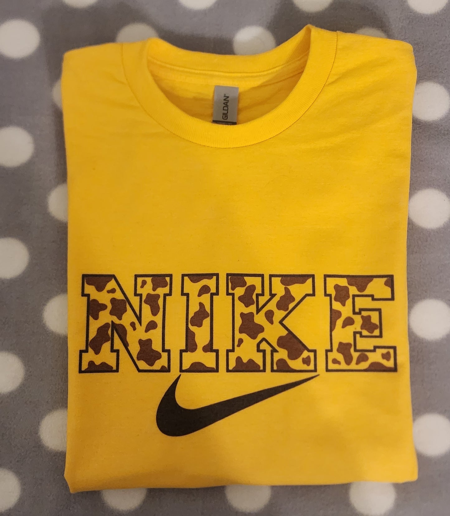 Cow print letters with Swoosh Sign